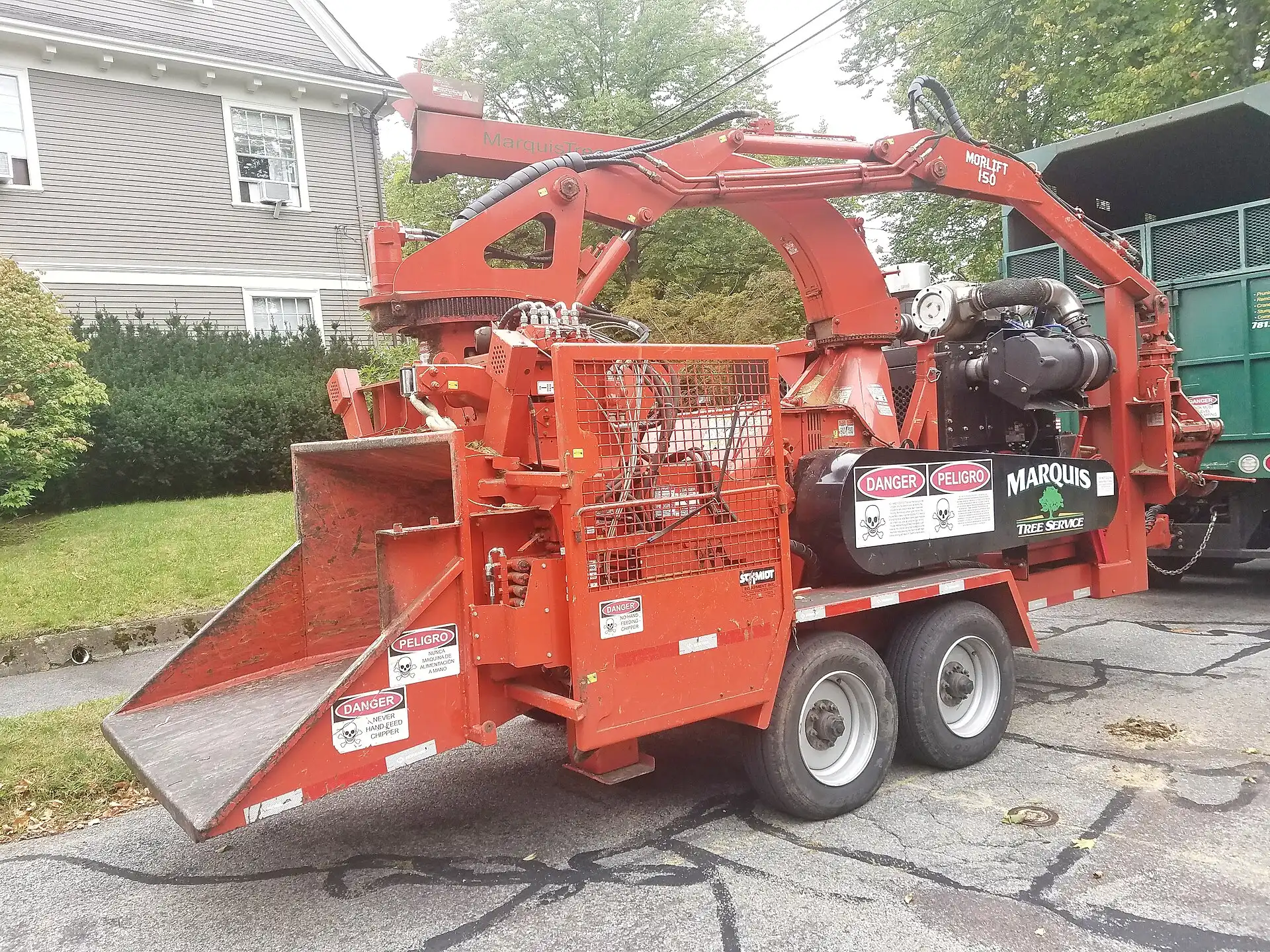 Wood chipper and crew truck set up on a residential street